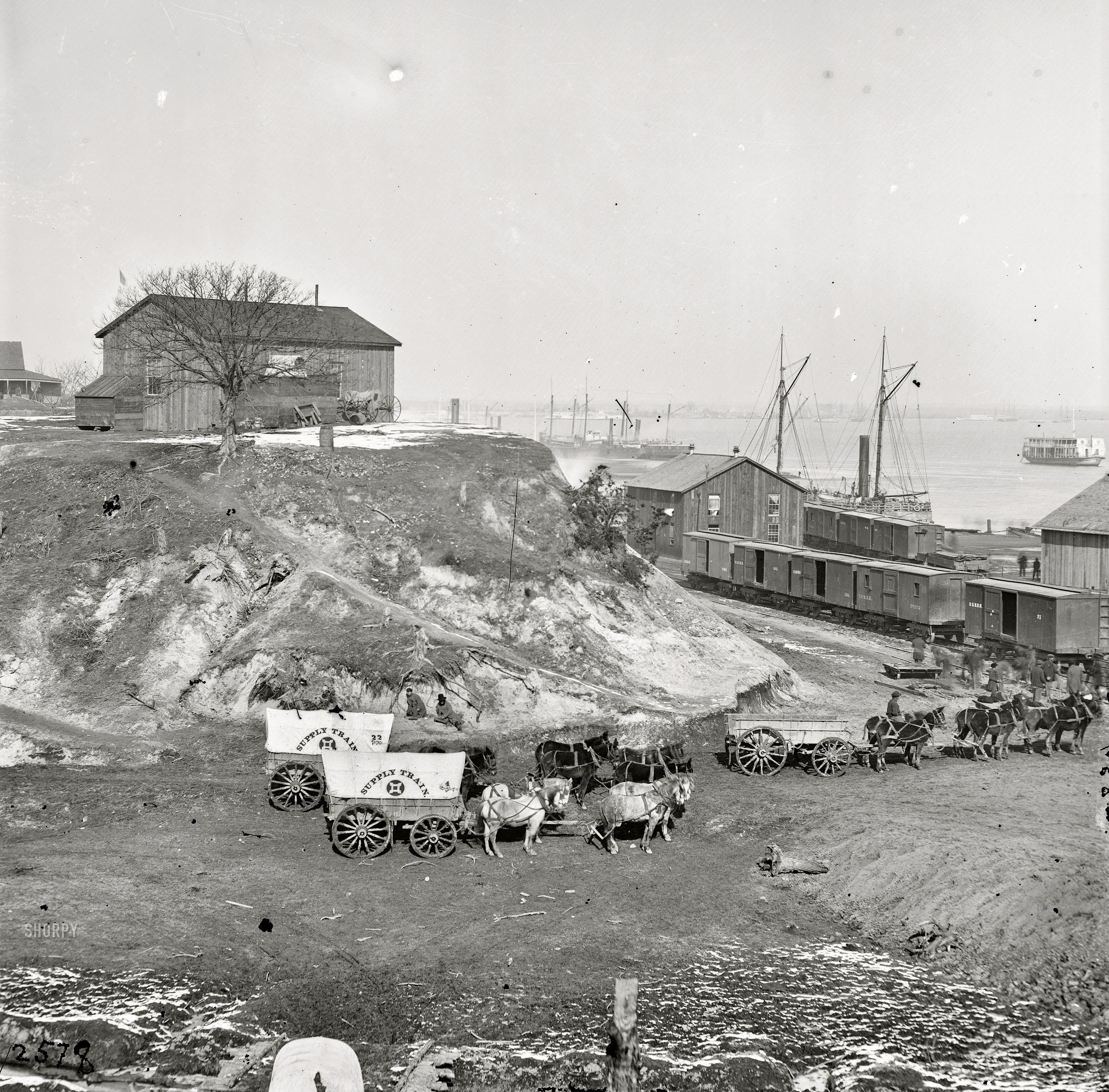 1865. City Point, Virginia. "General Patrick's headquarters and mail wharf." Wet plate glass negative, photographer unknown. View full size.
