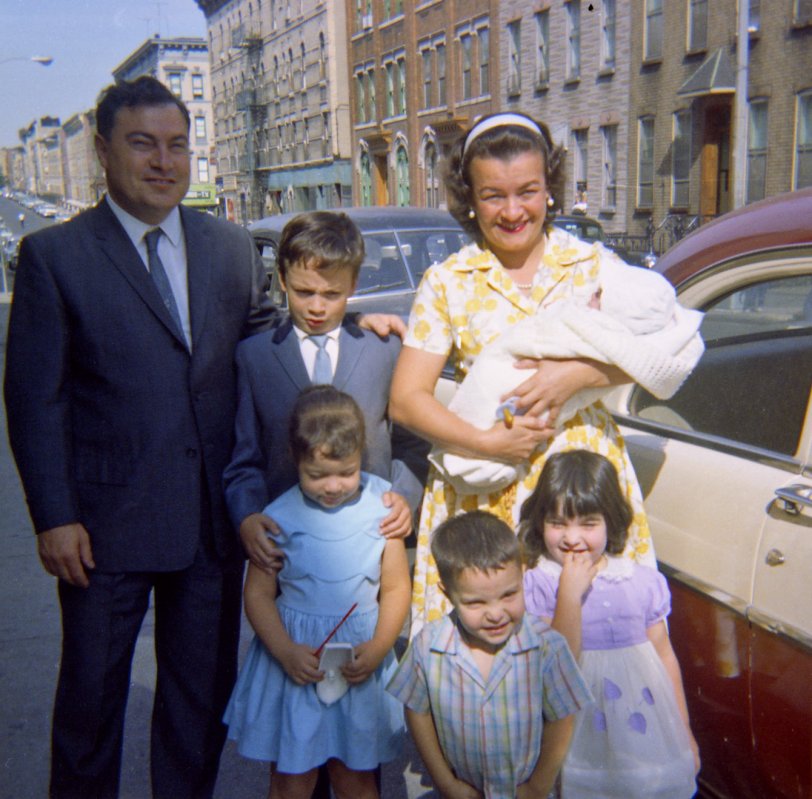 Taken on Hart Street in the Bushwick section of Brooklyn when we were taking my days-old brother Frank to church to be baptized.  Pictured are my Uncle Tony, my cousin Tony Jr., my Aunt Nydia (holding my brother), my cousin Marie, my sister Toni, and that's me in front. View full size.
