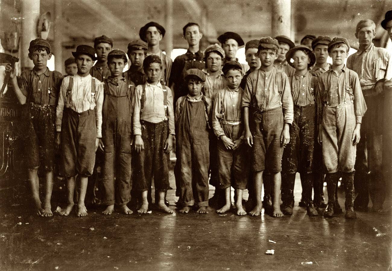 May 1911. Fries, Virginia. Some of the doffers in the Washington Cotton Mills. The smallest one said he was 15 years old but, for that matter, they are all "wise" to the necessity for being at least 14. All work. The group was posed by the overseer. View full size. Photo and caption by Lewis Wickes Hine.