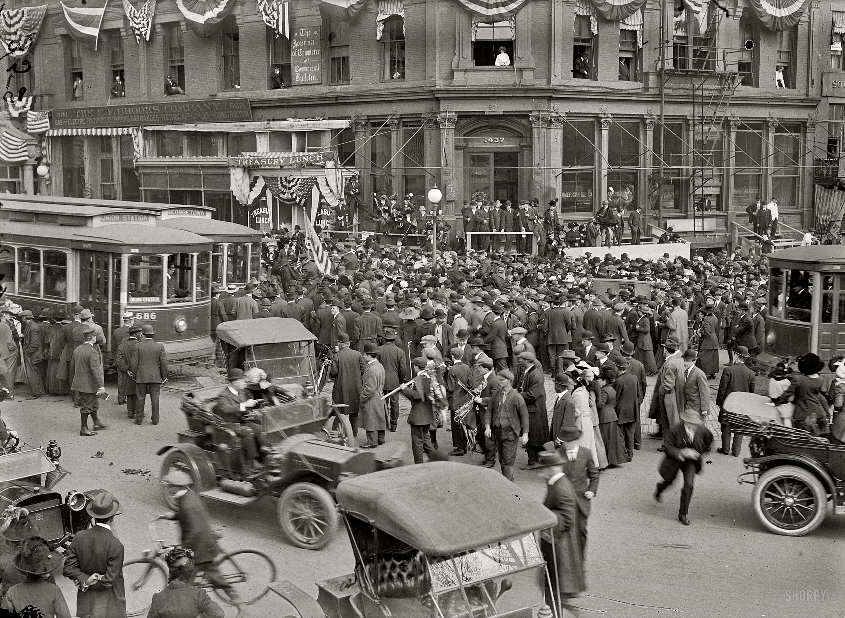 February 28, 1913. "Woman suffrage. Greeting hikers arriving from New York." The scene at Pennsylvania Avenue and 15th Street in Washington. From the pages of the Washington Post: "General" Rosalie Jones and her suffrage "army" marched triumphantly into the Capital shortly before noon yesterday, through the Capitol grounds and down Pennsylvania avenue, with an escort of local enthusiasts and citizens which fairly choked the streets and delayed traffic. It was one of the most remarkable street demonstrations ever seen here." The bunting is decoration for the upcoming presidential inauguration. View full size.