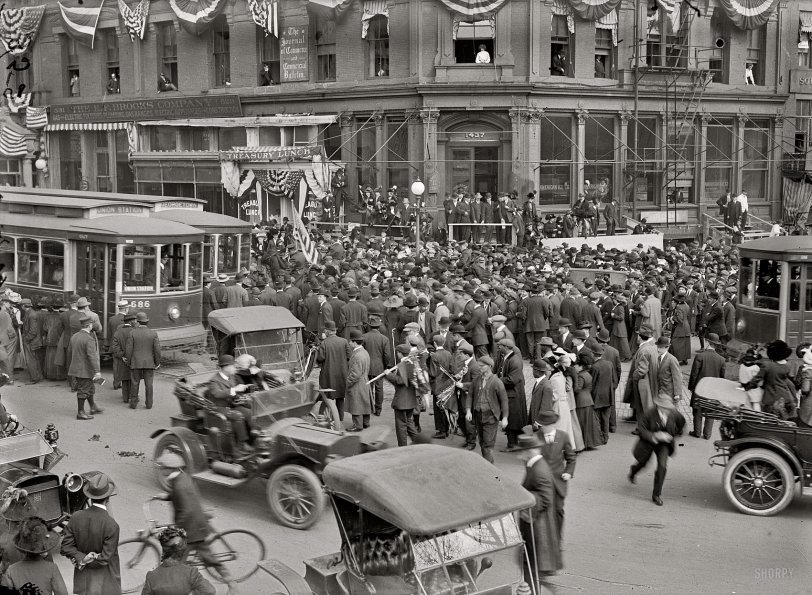 February 28, 1913. "Woman suffrage. Greeting hikers arriving from New York." The scene at Pennsylvania Avenue and 15th Street in Washington. From the pages of the Washington Post: "General" Rosalie Jones and her suffrage "army" marched triumphantly into the Capital shortly before noon yesterday, through the Capitol grounds and down Pennsylvania avenue, with an escort of local enthusiasts and citizens which fairly choked the streets and delayed traffic. It was one of the most remarkable street demonstrations ever seen here." The bunting is decoration for the upcoming presidential inauguration. View full size.
