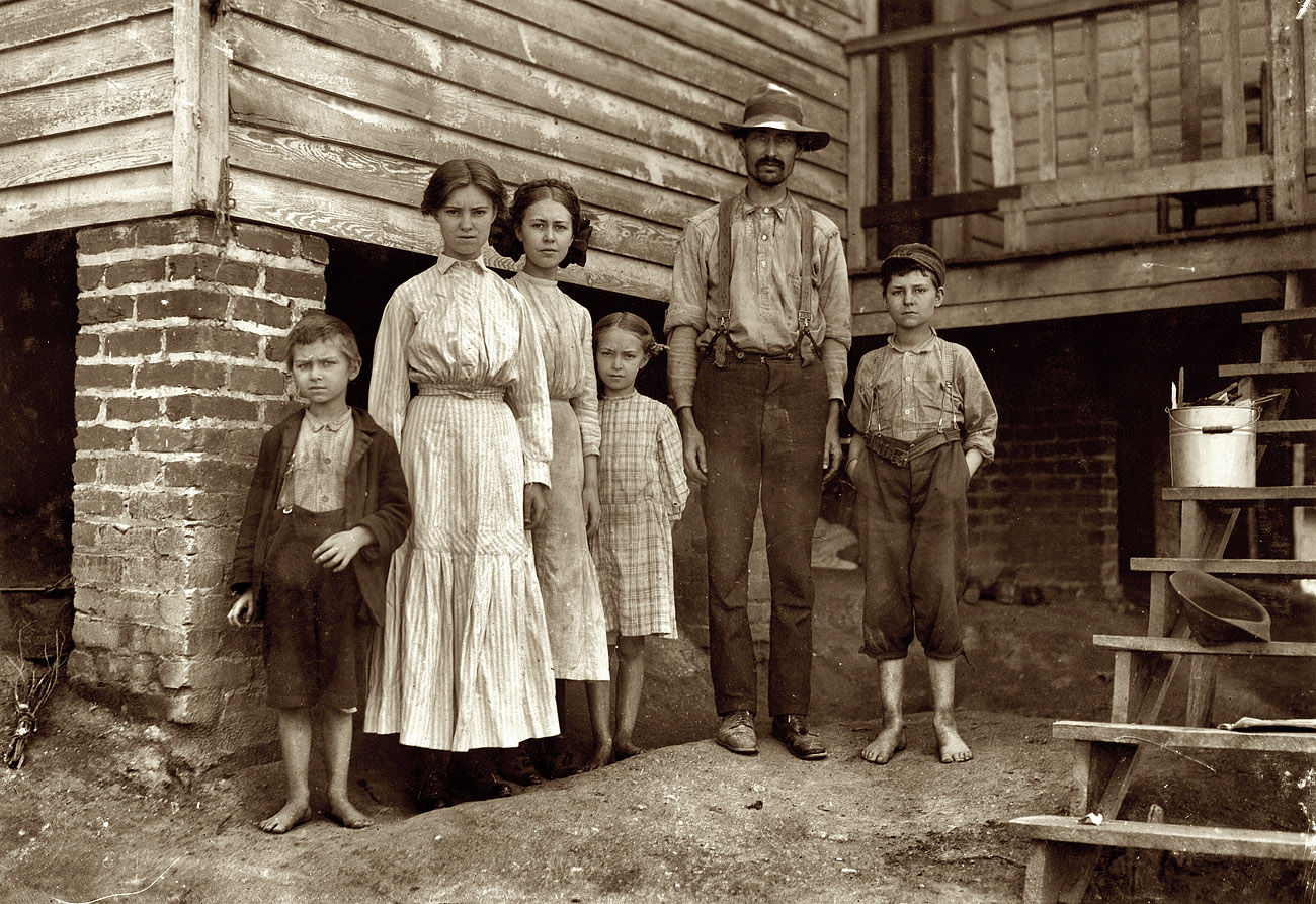 May 1911. Fries, Virginia. "T.J. Fields and family. Work at Washington Cotton Mills. The father cards, two girls spin, boy on right end picks up bobbins. Been working a year or two. Mother and smallest children not in photo." Photograph and caption by Lewis Wickes Hine. View full size.