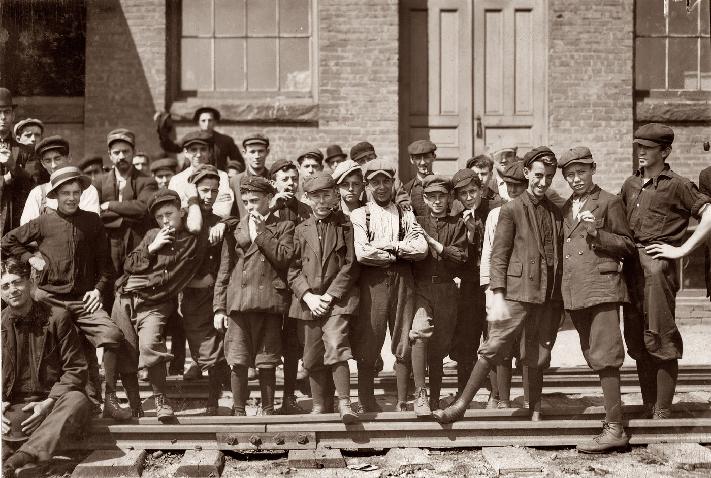 Young workers in front of Indian Mfg. Co., Indian Orchard, Massachusetts. September 1911. Photo by Lewis Wickes Hine. View full size.