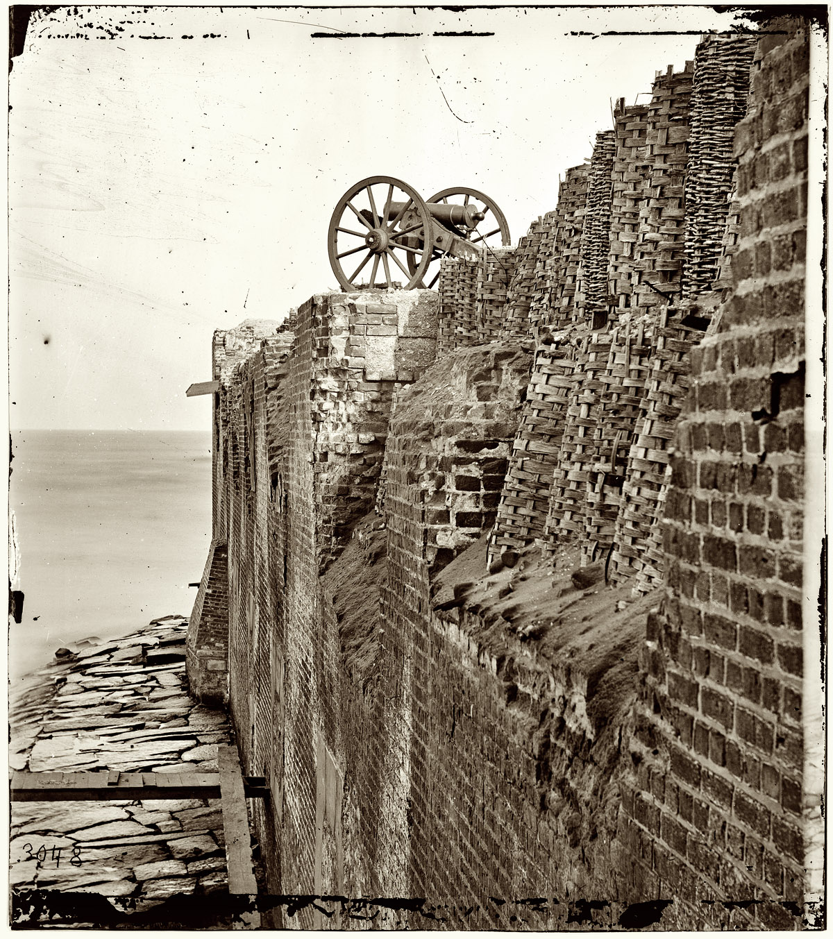 1865. "Charleston, South Carolina. Breach patched with gabions on the north wall of Fort Sumter." From photographs of the Federal Navy, and seaborne expeditions against the Atlantic Coast of the Confederacy, 1863-1865. Wet collodion glass plate negative, right half of stereograph pair, from Civil War photographs compiled by Hirst Milhollen and Donald Mugridge. View full size.