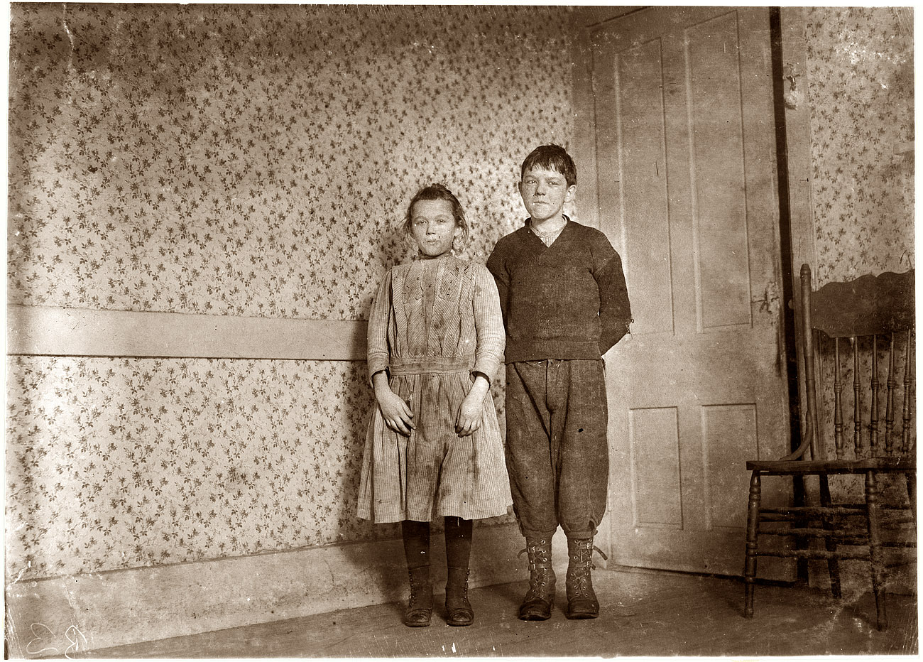 January 1912. "Veronica Mikula, says 12 years old, 93 N. Front Street. Steven Mikula (works in mill) says 15 years. Photo taken in spare unused room too cold to warm. They crowd together in kitchen. New Bedford, Massachusetts." View full size. Photograph and caption by Lewis Wickes Hine.