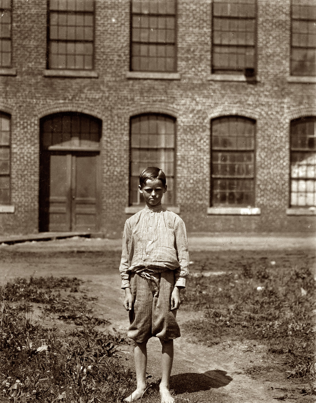 May 1912. Rock Hill, South Carolina. Arthur Newell, doffer in Manchester Mills. Three weeks at it. 70 cents a day. Said 12 years old. His father in the mill gets $12 a week, mother $9, sister $4.80, he gets $4.20, total $30 a week. "I had ruther go to school but the mill wanted me." View full size. Photo by Lewis Wickes Hine.