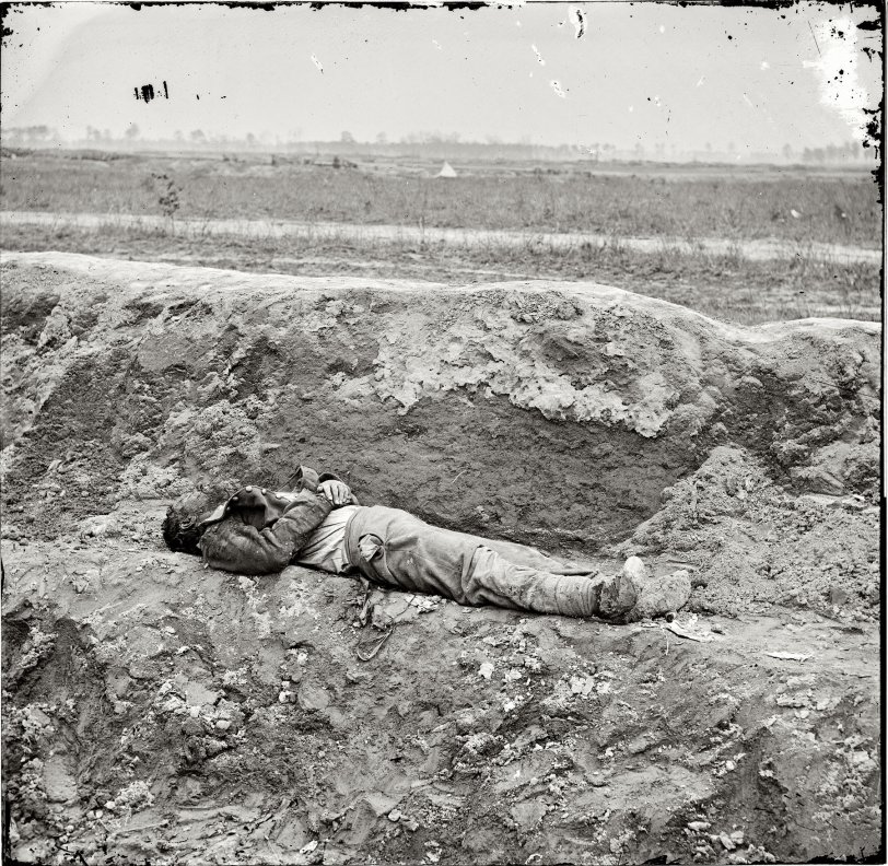 April 1865. Petersburg, Virginia. "Dead Confederate soldier." Wet plate glass negative, right half of stereo pair, by Thomas C. Roche. View full size.
