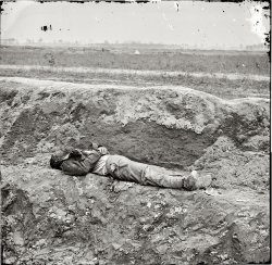 April 1865. Petersburg, Virginia. "Dead Confederate soldier." Wet plate glass negative, right half of stereo pair, by Thomas C. Roche. View full size.
The real face of warWhat a desolate string of images. Kind of spoils the fun of enrolling in the military... 
Also, someone seems to have picked the pocket of this poor fellow.
Agnus DeiQui tolis peccata mundi
Miserere nobis
Amen
Turned-Out PocketsThere were no "dog tags" then and so the soldier would write his name and hometown on a scrap of paper and carry it in his pocket so his body could be identified if needed. You will see the turned out pockets on almost all the dead. 
(The Gallery, Civil War, Thomas Roche)