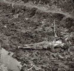 April 1865. Petersburg, Virginia. "Dead Confederate soldier outside the walls of Fort Mahone." Wet plate glass negative, left half of stereo pair, by Thomas C. Roche. Civil War glass negative collection, Library of Congress. View full size. There's a soundtrack and slide show for these photos here.