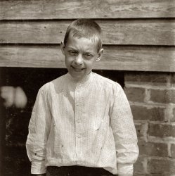 May 1912. Spartanburg, South Carolina. Tom Polk, "goin' on 13." Prematurely old, works in Beaumont Mill. View full size. Photograph by Lewis Wickes Hine.
Squinting for HineOf course being dragged out of the dark mill and posed in the sunlight probably didn't help his expression either.
Tom PolkBack when the men were men and so were the boys.
I look at this and think about my 40-year-old co-worker complaining about how Barney's no longer sells his favorite mango-papaya anti-wrinkle eye cream. 
What is wrong with his mouth?Are his lips just extremely chapped? Actually looks like dried blood as it appears to be on his teeth also.
[Beverage mustache. - Dave]

(The Gallery, Kids, Lewis Hine)