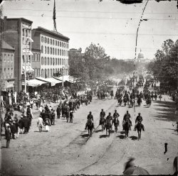 May 1865. "Another artillery unit passing on Pennsylvania Avenue near the Treasury." Wet plate glass negative by Mathew Brady. View full size.
Victory ParadeThis is the victory parade of the Union Army. Three days of parading and festivities marked the end of the Civil War. I've seen a picture of the official reviewing stand with President Johnson, General Grant, and other notables. The stand was decorated with the names of battles.
It&#039;s so strangeto think my great-great grandpa could be in that crowd.  I would love to find a picture of him during that time.
The RailsThose two sets of rails we see in the street...would some Shorpy history expert be able to say what ran on them? And it appears the rails themselves have an unusual design compared to a common railroad track. An no apparent rail ties underneath would indicate whatever rolled on those tracks couldn't have been too heavy.
[Those are streetcar tracks. - Dave]

Glass PlatesDoes anyone know anything about developing glass plate negatives?
ApugYou can likely find more information than you ever thought possible at http://www.apug.org
That's the Analog Photography Users Group and there are a lot of people doing "old school" photography.
AhaStreetcars. Thanks for the info. Your knowledge is so helpful in understanding the contents of these amazing photos. 
Glass Plate PhotographyPhotos of this era are all "wet plate", a lengthy process in which the plate is coated with a chemical called a colloid, then placed in a light-proof holder for use in the camera.  After exposure it must be developed before drying.  Lots of info online.  Sounds like a fascinating craft for someone with time and an interest in exacting hobbies.  After around 1880 "dry plate" came in (thanks partly to George Eastman) and you could buy your plates ready- made and develop at your leisure.  
(The Gallery, Civil War, D.C., Horses, Mathew Brady, Streetcars)