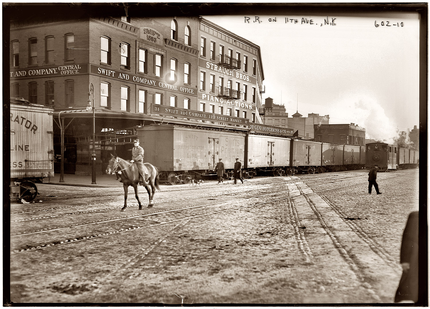 Equestrian signalman on the New York Central's Eleventh Avenue freight line circa 1911. In a 1930 article on the West Side tracks' demise, the New York Times wrote of the "eight men and twenty-four horses comprising the famous 'cowboy troop' [or 'West Side Cowboys'] whose function it has been for years to ride ahead of the puffing locomotives as they wheeled along Death Avenue." The dangerous street-level tracks were eventually replaced by a 1½-mile viaduct, the High Line, that after decades of abandonment is being turned into a long, thin elevated park. View full size. 5x7 glass negative, George Grantham Bain Collection.