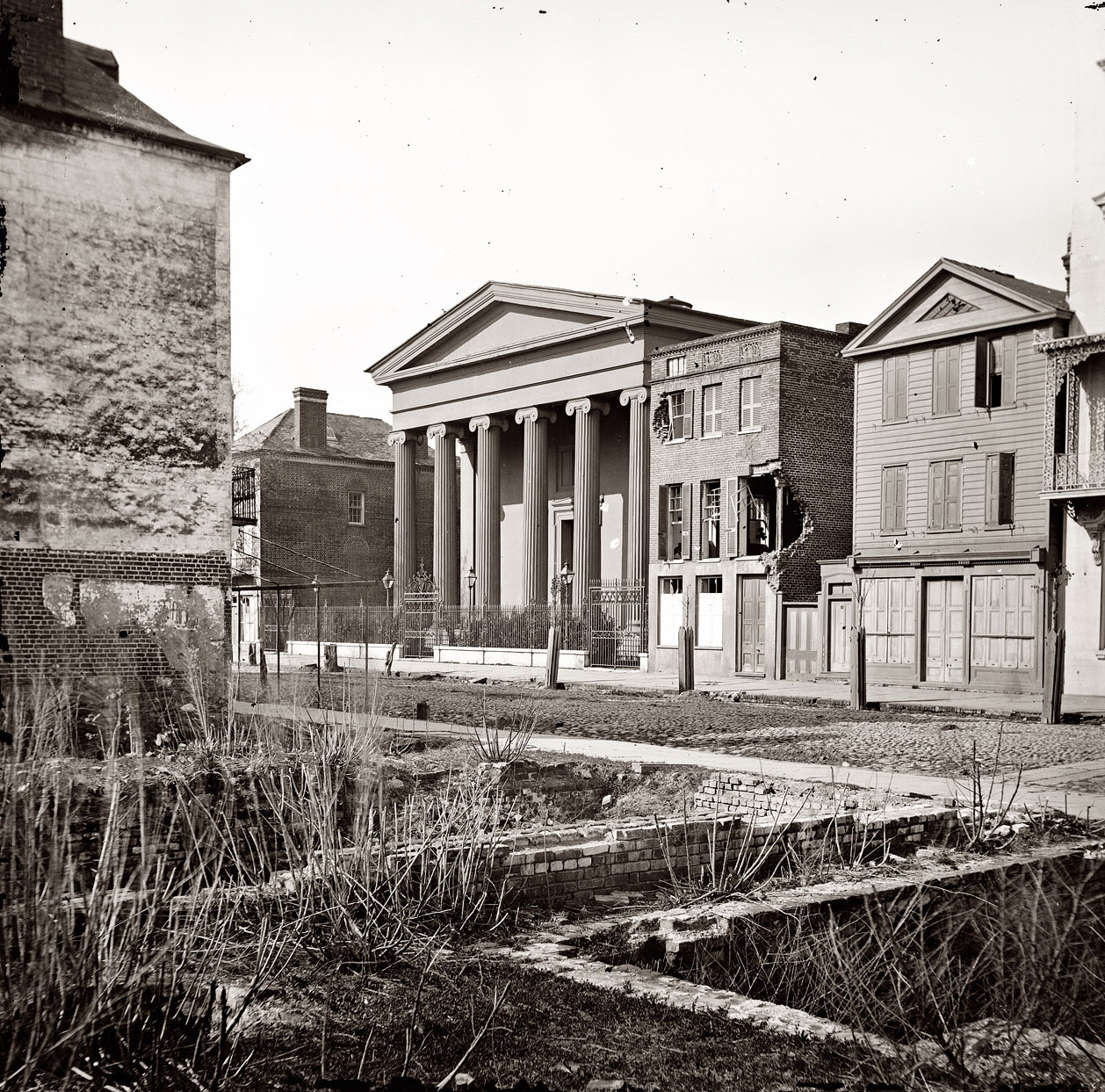 1865. "Charleston, South Carolina. Hibernian Hall (with columns; 105 Meeting Street), place of meeting after the burning of Secession Hall. Photograph of the Federal Navy, and seaborne expeditions against the Atlantic Coast of the Confederacy." View full size. Left half of wet-collodion glass-plate stereograph.
