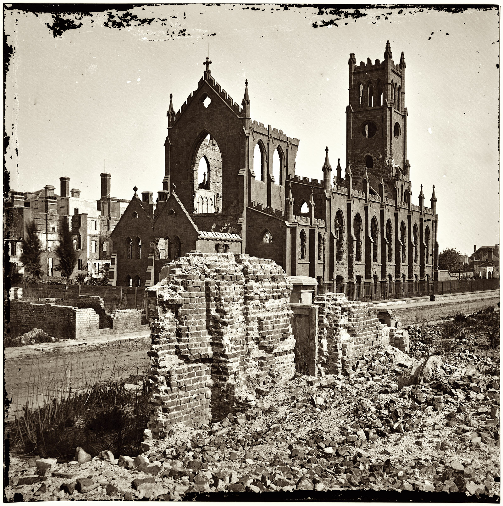 1865. "Charleston, South Carolina. Ruins of the Cathedral of St. John and St. Finbar (Broad and Legare Streets) destroyed in the fire of December 1861." From photographs of the Federal Navy and seaborne expeditions against the Atlantic Coast of the Confederacy, 1863-1865. Glass plate negative, left half of stereograph pair, from Civil War photos compiled by Milhollen and Mugridge. View full size.