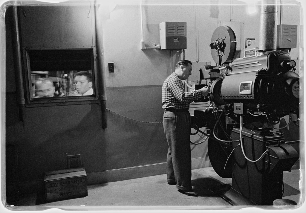 Movie theater projectionist somewhere in the Washingon, D.C., area. Photograph by Marion S. Trikosko, 1958.  View full size.