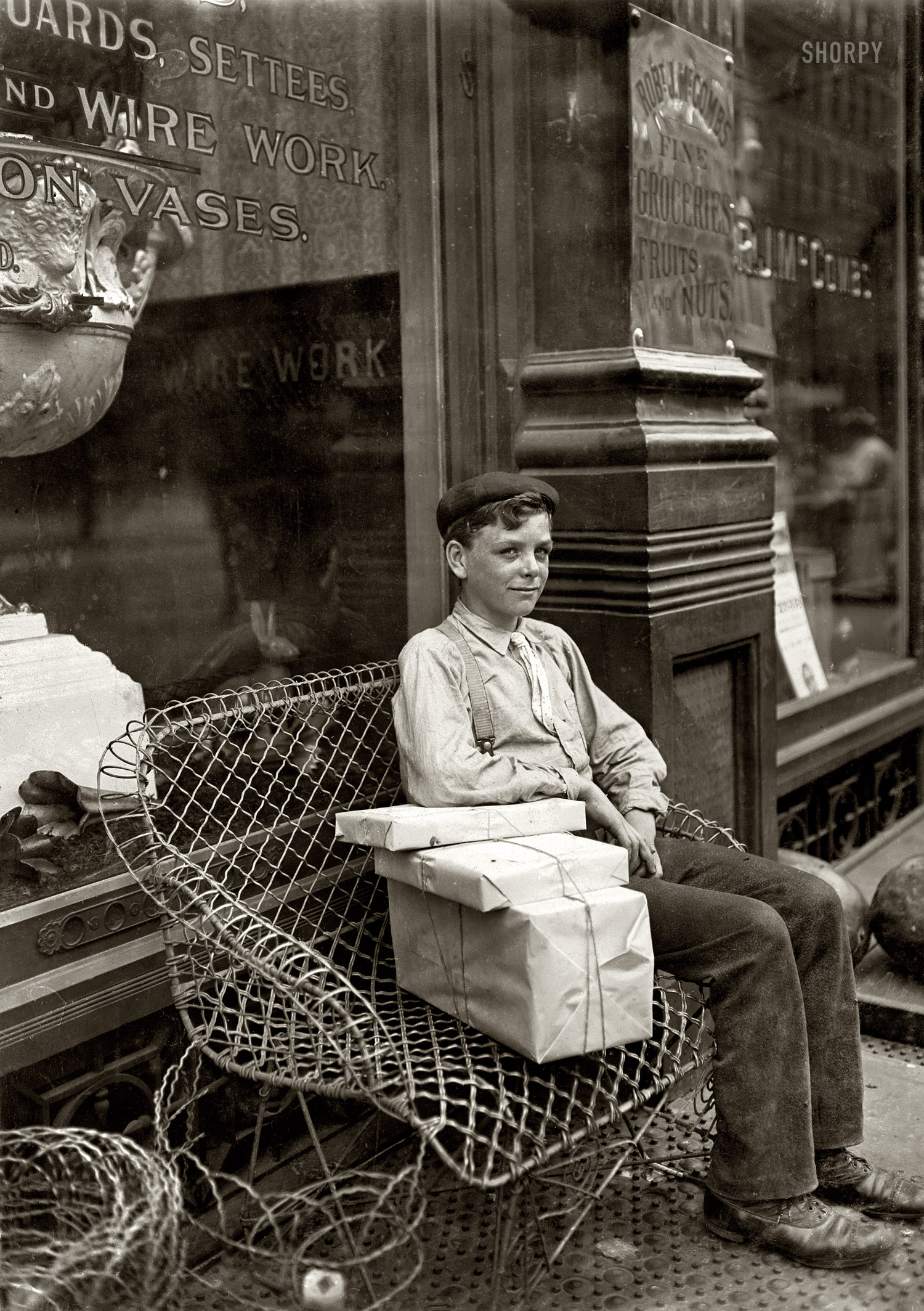 August 1908. "An Enforced Rest. Harry Swope, aged 15, 426 Elm Street, Newport, Kentucky. Carrying heavy bundles of paper for a News & Stationery company." Photo and caption by Lewis Wickes Hine. View full size.