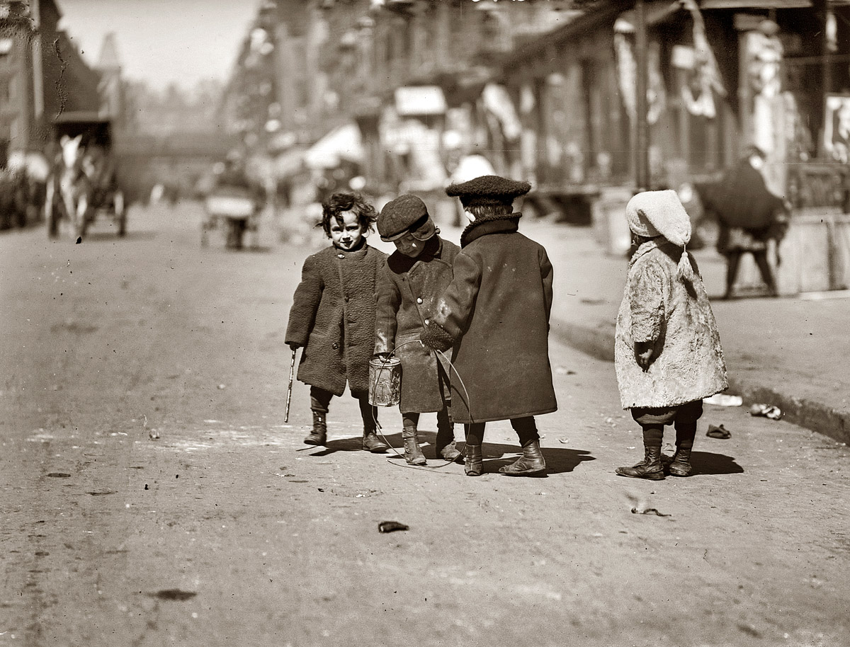 April 2, 1909. Children at play in the streets of New York, bundled against the cold. View full size. George Grantham Bain Collection. The tyke on the right reminds me of Edward Gorey's ill-fated tots. What calamity will befall her?