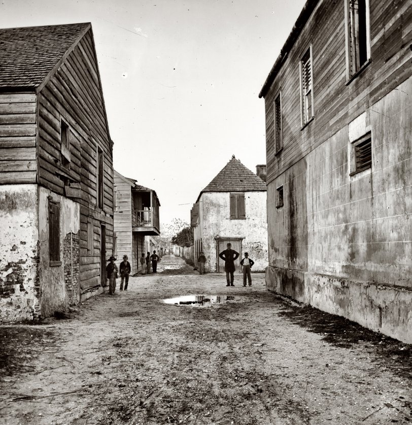 A St. Augustine, Florida, street view circa 1865. View full size. Left half of a wet-collodion glass-plate stereograph made by Samuel A. Cooley.
