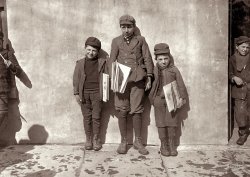 March 1909. Hartford, Conn. "John Pento, 14 years old, has been selling for seven years. Daniel and Angelo, his twin brothers, are 7 years old, have been selling one year. Sell until 8 p.m. some nights." Photo by Lewis Wickes Hine. View full size.