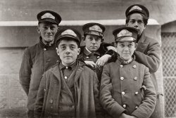 Western Union messengers in Hartford, Conn. March 1909. They are on duty, alternate nights, until 10 P.M. Messenger #32 is Thomas De Lucco, 9 years old, who works second job as newsboy. View full size. Photo by Lewis Wickes Hine.
