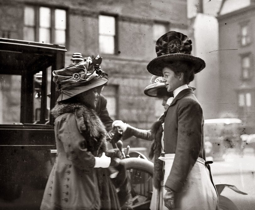 "Miss Twombly, whip of Ladies' Coach Run, and two other ladies beside coach on street." April 26, 1909. View full size. George Grantham Bain Collection.