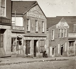 Whitehall Street, Atlanta, 1864. This photo of a black Union soldier posted at a slave auction house in Atlanta is one of hundreds taken by George N. Barnard during Gen. Sherman's occupation of the city in the fall of 1864. Many were destroyed in the conflagration that erupted upon Sherman's firing of Confederate munitions stores when he departed on Nov. 15. View full size.