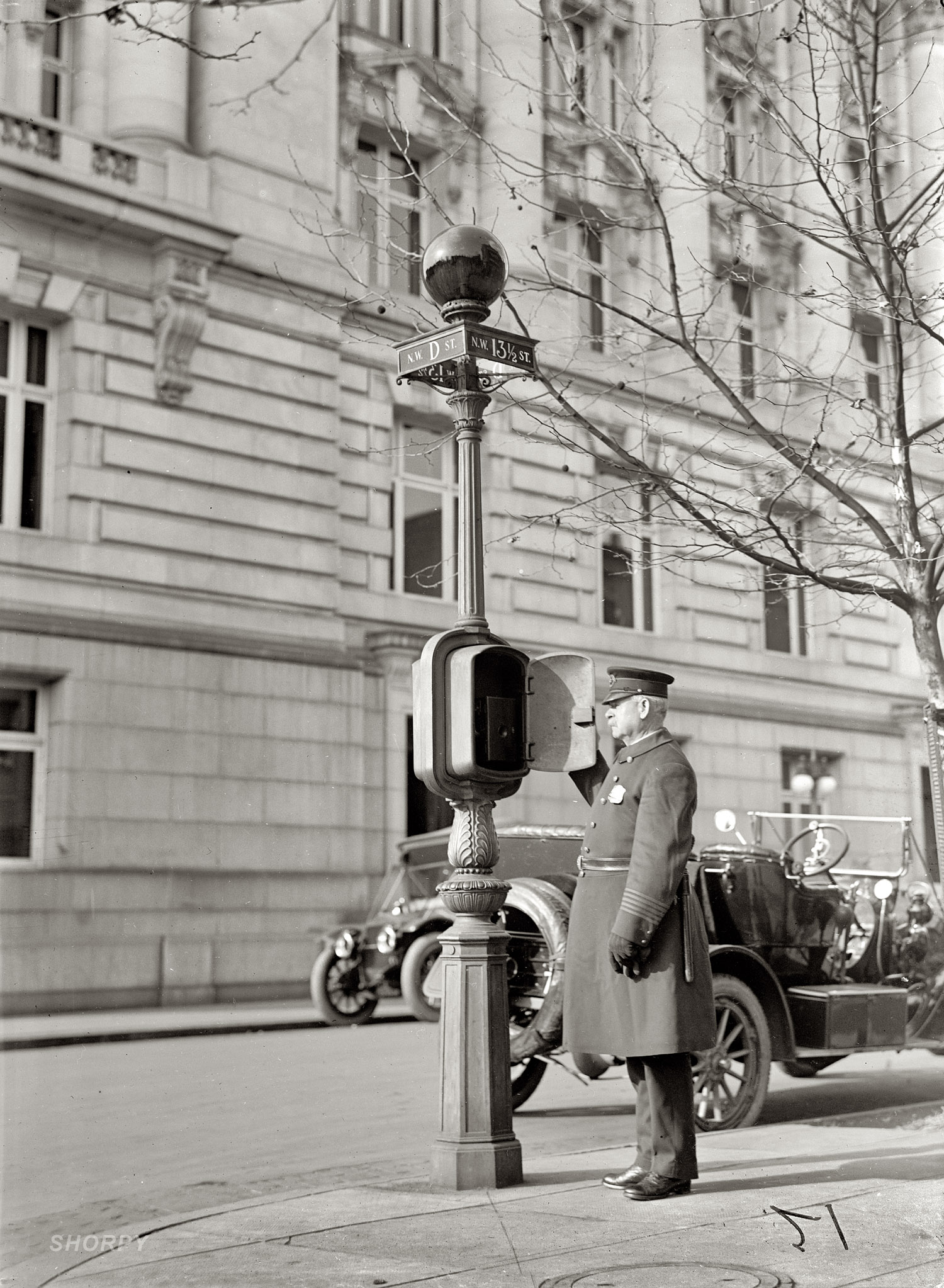 Washington, D.C., circa 1912. "Police Call Box." Finally we have a closeup of a mysterious item of street furniture on view in many of our urban scenes -- what looks like a streetlight with a dark globe. These were telephones with a direct line to the police station. When a call went out, the red illuminated globe showed arriving officers where help was needed. This one was downtown at 13½ and D streets N.W. Harris & Ewing Collection glass negative. View full size.