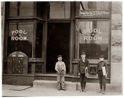 May 1910. "A Pool Room at Chouteau & Manchester, St. Louis, where these boys play pool and smoke while waiting for papers. The smallest boy is 9 years old and sells until 9 P.M." Photograph by Lewis Wickes Hine. View full size.