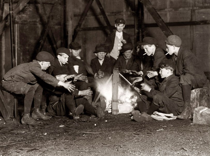 St. Louis, Missouri. May 7, 1910. "Jefferson Street Gang of newsboys at 10 P.M. over campfire in corner lot behind bill-board. Jefferson Street near Olive." Photograph and caption by Lewis Wickes Hine. View full size.