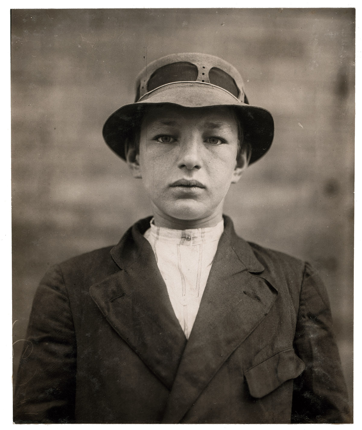 May 1910. Wilmington, Delaware. "William Gross, 516 Tatnall Street. Newsboy, 15 years of age. Selling papers 5 years. Average earnings 50 cents per week. Father, carpenter, $18 week. Selling newspapers own choice, to get money to go to moving picture shows. Visits saloons. Smokes sometimes. "Serves papers" to prostitutes. On May 25 William gave to investigator a list of houses of prostitution written in his own handwriting, to which he serves papers. He also tells a story of occasionally guiding strangers to these houses, for which he receives from 15 cents to a quarter." Photograph by Lewis Wickes Hine. View full size.