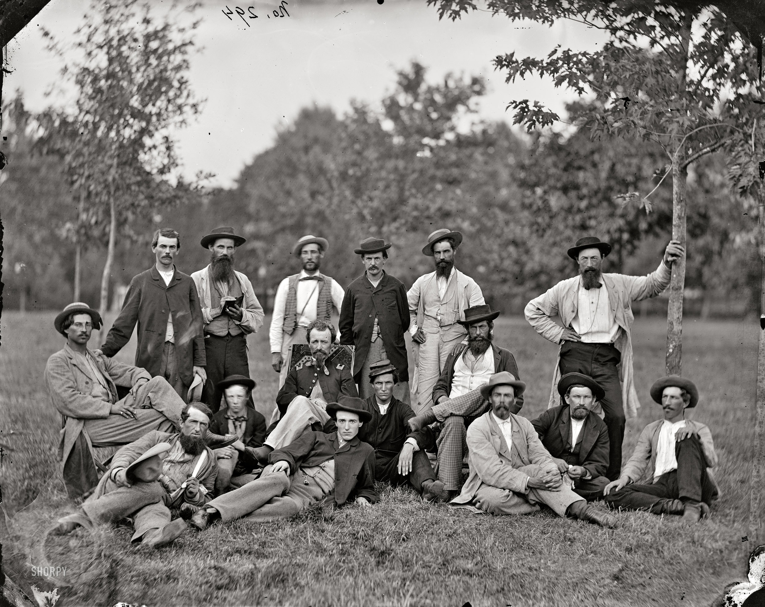 March 1864. "Brandy Station, Virginia. Scouts and guides of the Army of the Potomac." From photographs of the main Eastern theater of the war, winter quarters at Brandy Station. Standing, left to right: James Doughty, James Cammack (?), unknown, Henry W. Dodd, unknown, unknown. Seated: John Irving, Lt. Robert Klein of the 3d Indiana Cavalry, Dan Cole. On ground: Dan Plue, Lt. Klein's son, W.J. Lee, unknown, Mr. Wood, Sanford Magee, John W. Langdon. Wet-plate glass negative, photographer unknown. View full size.
