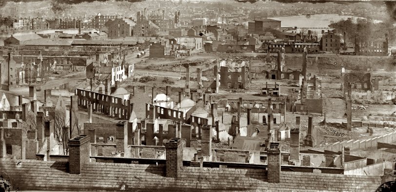 Richmond, Virginia, in April 1865 showing the burned district along the James River. From photographs of the main Eastern theater of war and fallen Richmond compiled by Hirst Milhollen and Donald Mugridge. View full size.
As the sun rose on Richmond, such a spectacle was presented as can never be forgotten by those who witnessed it. All the horrors of the final conflagration, when the earth shall be wrapped in flames and "melt with fervent heat," were, it seemed to us, prefigured in our capital. The roaring, crackling and hissing of the flames, the bursting of shells at the Confederate Arsenal, the sounds of the Instruments of martial music, the neighing of the horses, the shoutings of the multitudes, gave an idea of all the horrors of Pandemonium. Above all this scene of terror hung a black shroud of smoke through which the sun shone with a lurid angry glare like an immense ball of blood that emitted sullen rays of light, as if loath to shine over a scene so appalling. Then a cry was raised: "The Yankees! The Yankees are coming!" — Richmond resident Sallie Putnam
Upon evacuation of the city, the Confederate government authorized the burning of warehouses and supplies, which resulted in the destruction of factories and houses in the business district. Before the charred ruins of Richmond had cooled, General Robert E. Lee, with the remnant of his army, surrendered to Ulysses Grant at Appomattox Court House on April 9, 1865. [From Embattled Capital, on the National Park Service's Richmond National Battlefield web page.]
