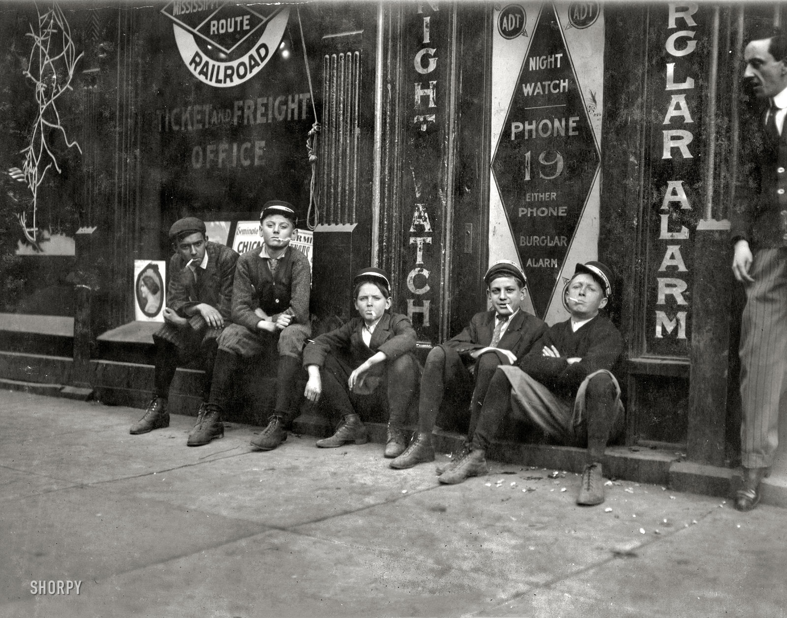 November 1910. Birmingham, Alabama. "A.D.T. boys (telegraph messengers). 'They all smokes.' " Photograph by Lewis Wickes Hine. View full size.