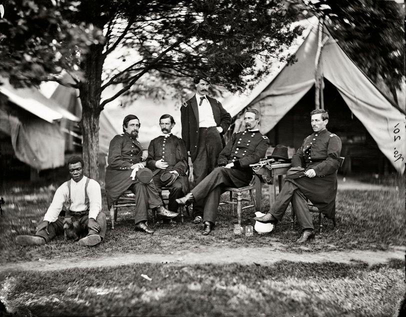 July 1865. "Washington, District of Columbia. Brevetted Brigadier General Napoleon Bonaparte McLaughlen (seated, second from right) and staff." Wet collodion glass plate negative, photographer unknown. View full size.
