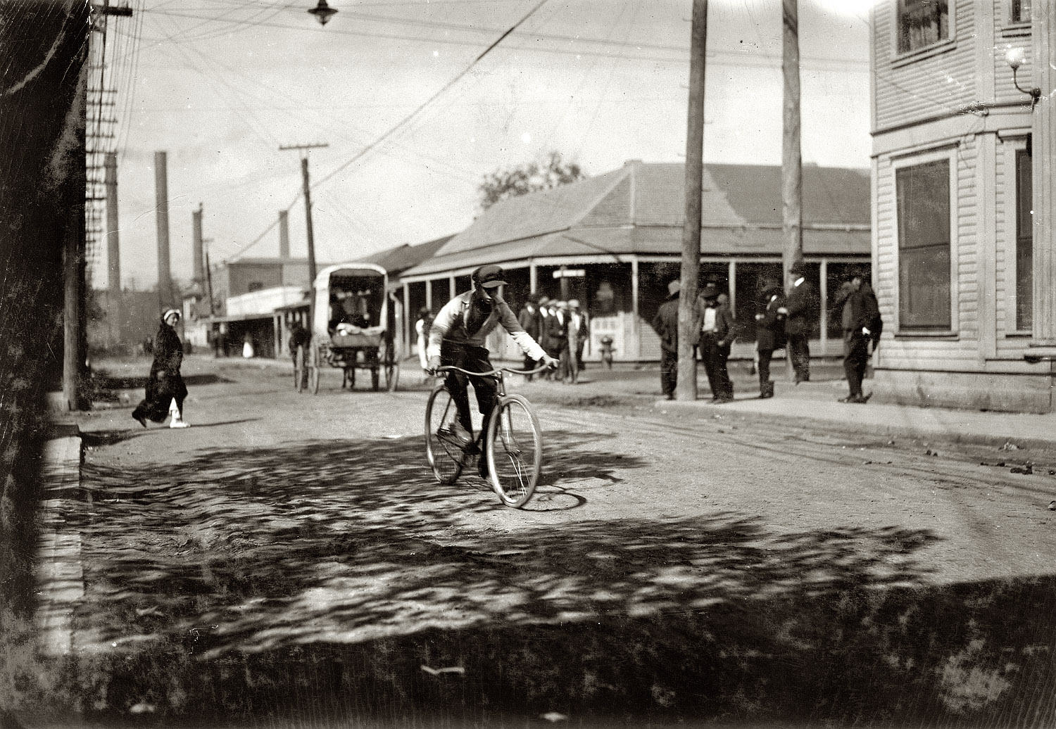 Dallas, October 1913. "Messenger boy in the heart of the Reservation (Red Light). Prostitutes run back and forth. Business beginning at mid-day. I saw messenger boys and delivery boys for drug stores from 15 years upward. Some still younger told me that they go there. This was in spite of a strong agitation being waged to close up the resorts." Photo and caption by Lewis Wickes Hine. View full size.