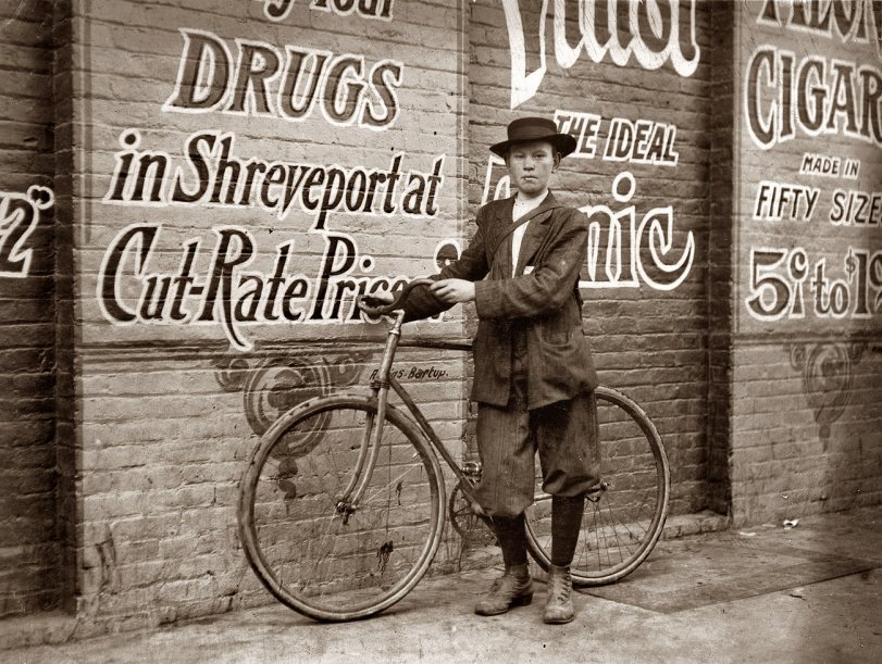 November 1913. Shreveport, Louisiana. Howard Williams, 13-year-old delivery boy for Shreveport Drug Company. He works from 9:30 a.m. to 10:30 p.m.; has been here three months. Goes to the Red Light every day and night. Says that the company could not keep other messenger boys, they work them so hard. Photograph and caption by Lewis Wickes Hine. View full size.
