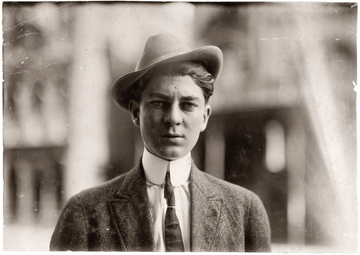 "Durward Nickerson, Western Union messenger #55. Birmingham, Alabama. 18 years old. Lives in Bessemer, R.F.D. #1. Saturday night, Sept. 26, 1914, he took investigator through the old Red Light on Avenue A, pointed out the various resorts, told about the inmates he has known there. Only a half dozen of them were open now. Durward has put in two years in messenger work and shows the results of temptations open to him. He has recently returned from a hobo trip through 25 states. He was not inclined to tell much about the shady side of messenger work, but one could easily see that he has been through much that he might have avoided in a profitable kind of work." View full size. Photo by Lewis Wickes Hine.