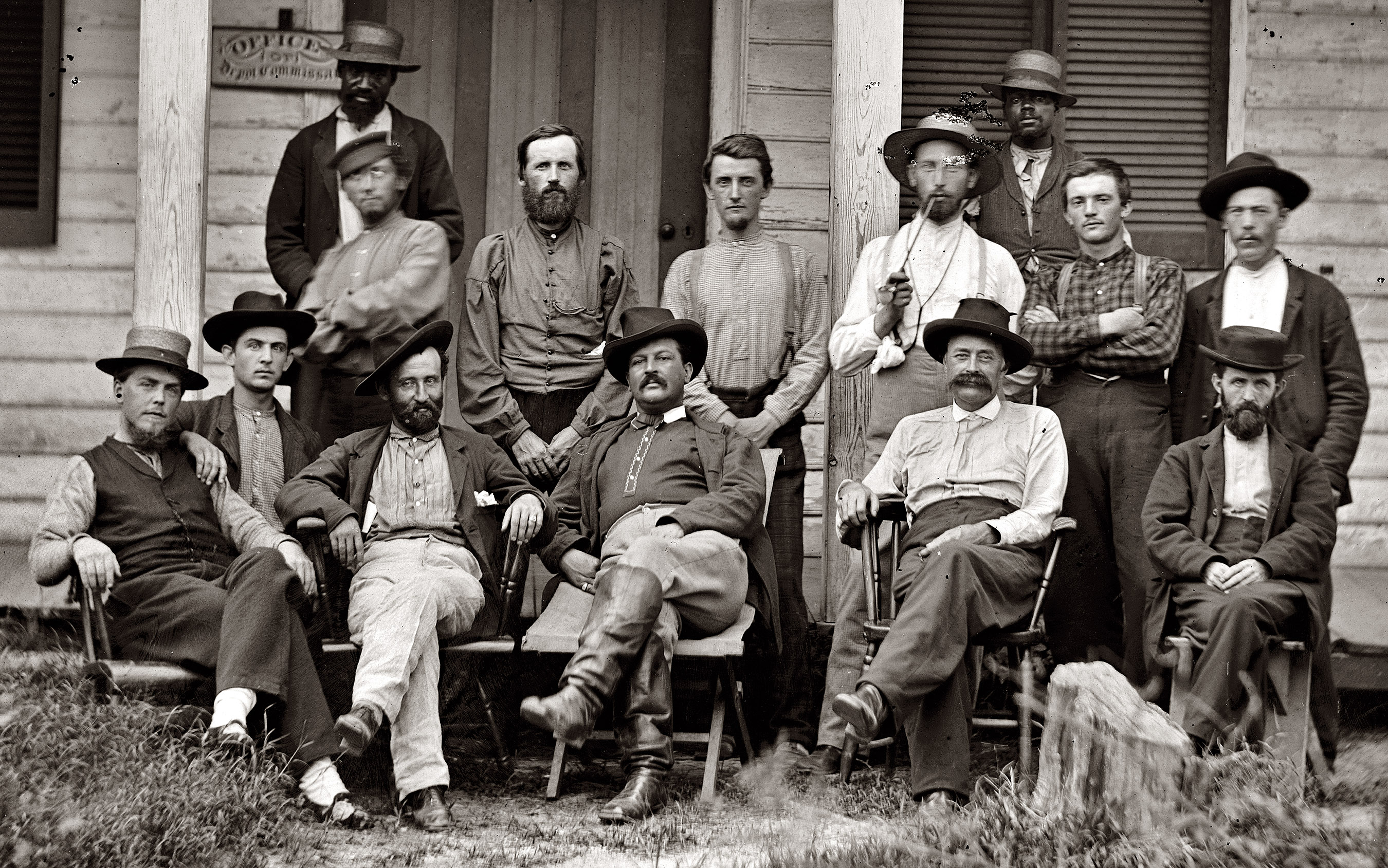 A closeup of the gents in the 1864 Civil War photo two doors down. An interesting variety of smoking materials, headgear and footwear. View full size.