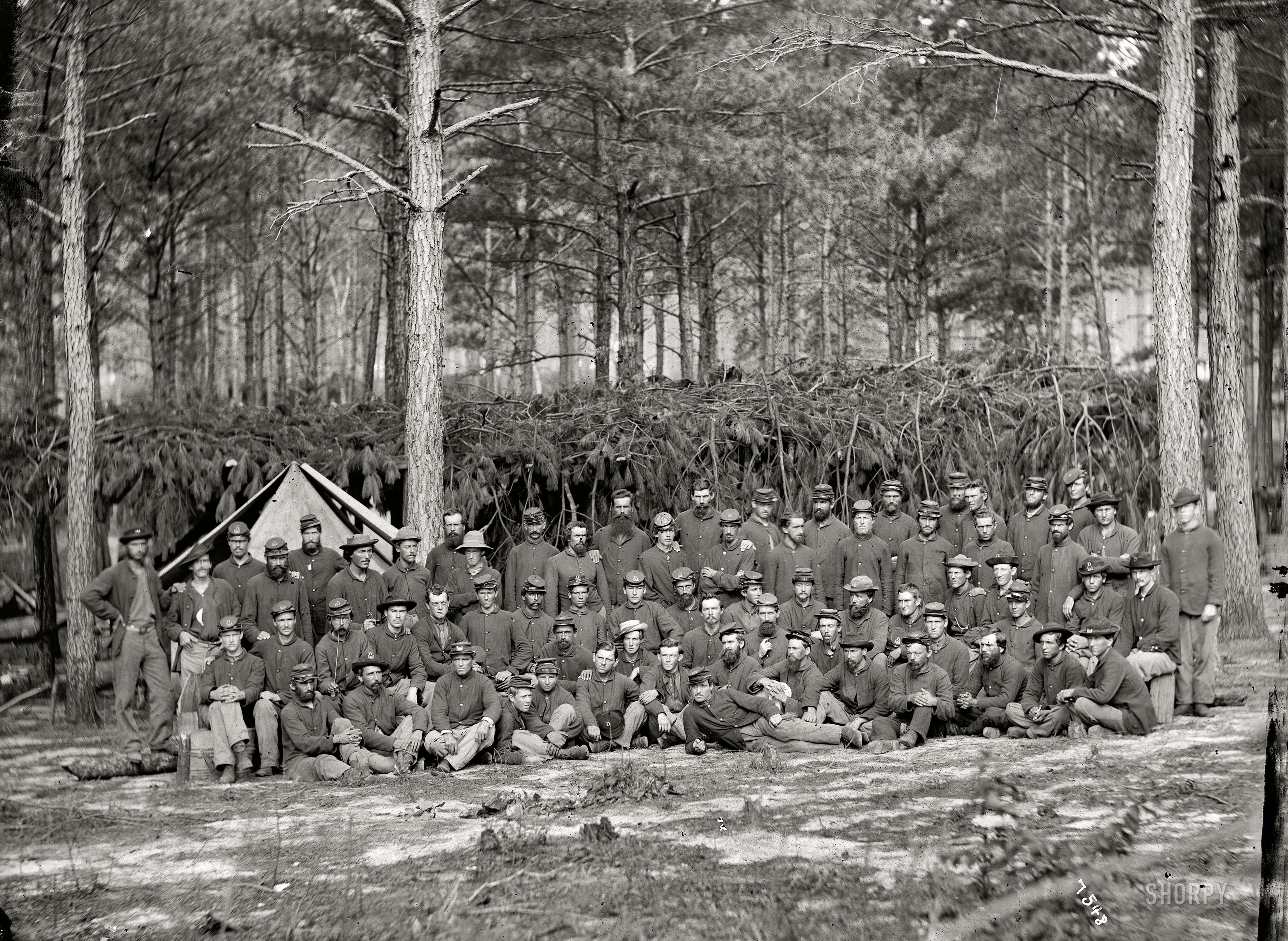 August 1864. "Group of men of Company D, U.S. Engineer Battalion, in front of Petersburg." Wet plate glass negative, photographer unknown. View full size.