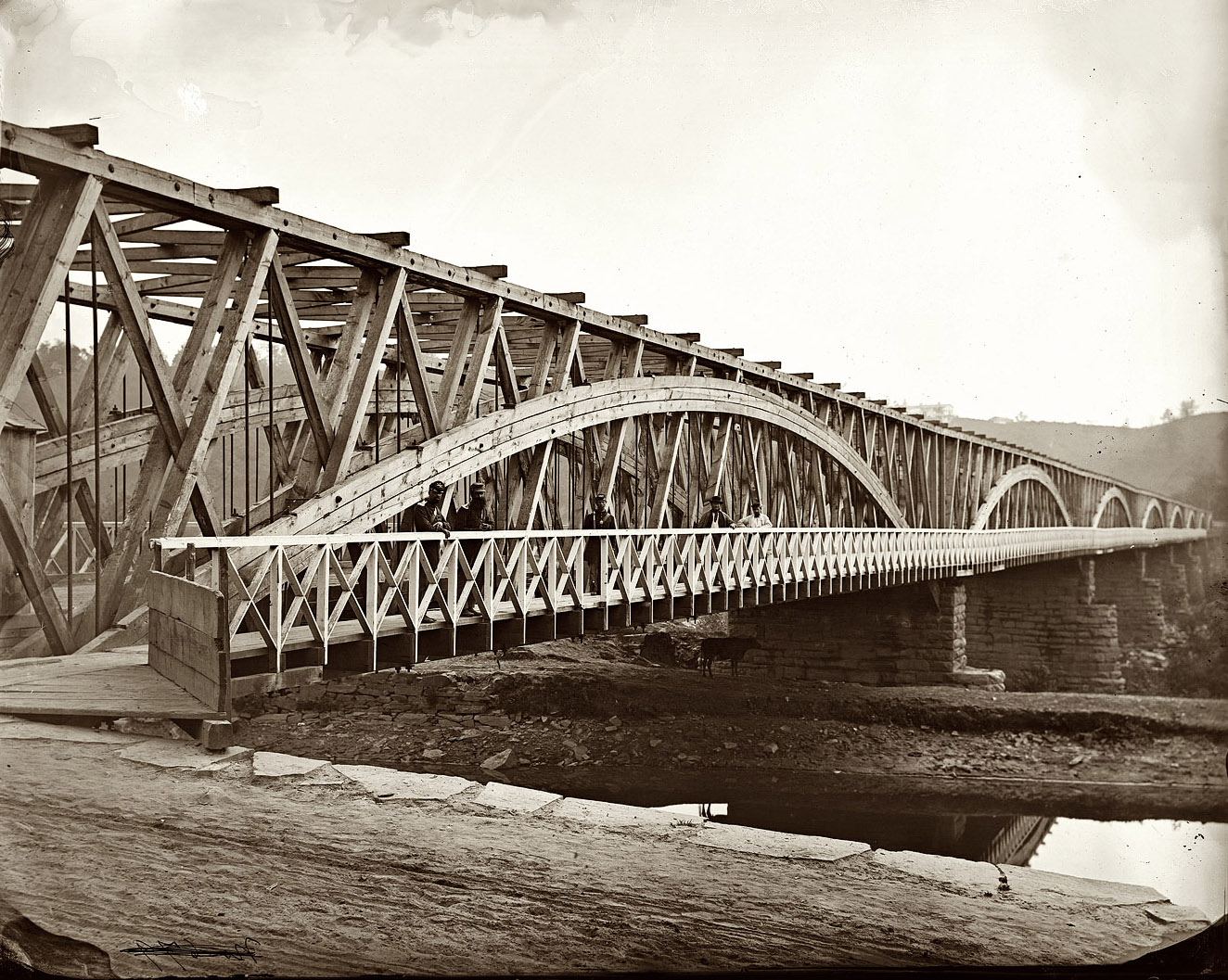 The Chain Bridge over the Potomac River circa 1865, with the Chesapeake & Ohio Canal in the foreground. View full size. Wet collodion glass plate negative by William Morris Smith. From negatives compiled by Milhollen and Mugridge.