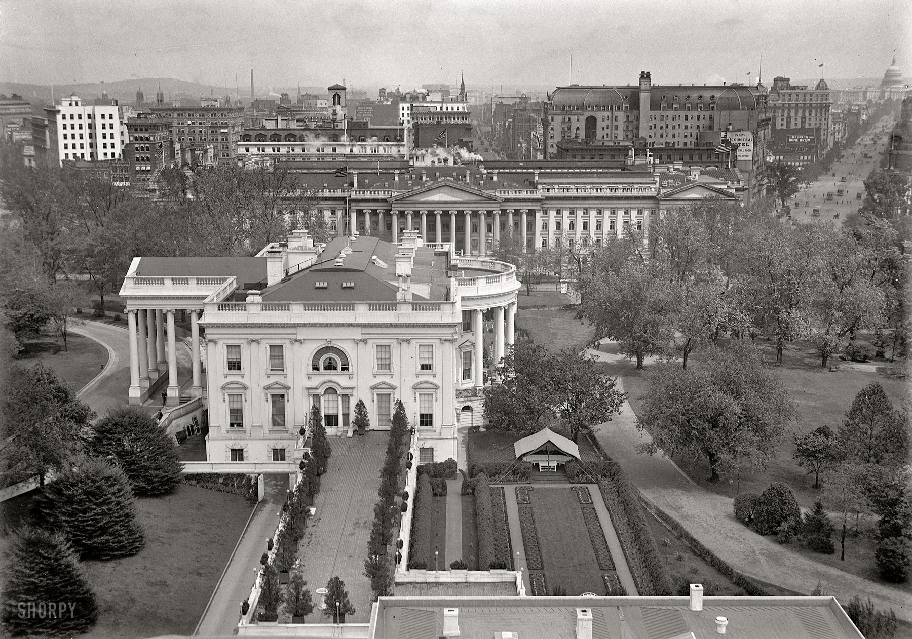 1914. "White House tent in Rose Garden." A view of the executive mansion from over the West Wing looking east past the Treasury and along Pennsylvania Avenue to the Capitol. Harris & Ewing Collection glass negative. View full size.
