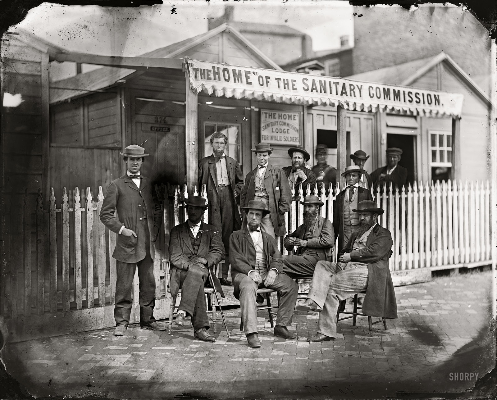 June 1863. "Washington, D.C. Sanitary Commission workers at the entrance of the Home Lodge for Invalid Soldiers." From photographs of the U.S. Sanitary and Christian Commissions. Wet plate glass negative. View full size.