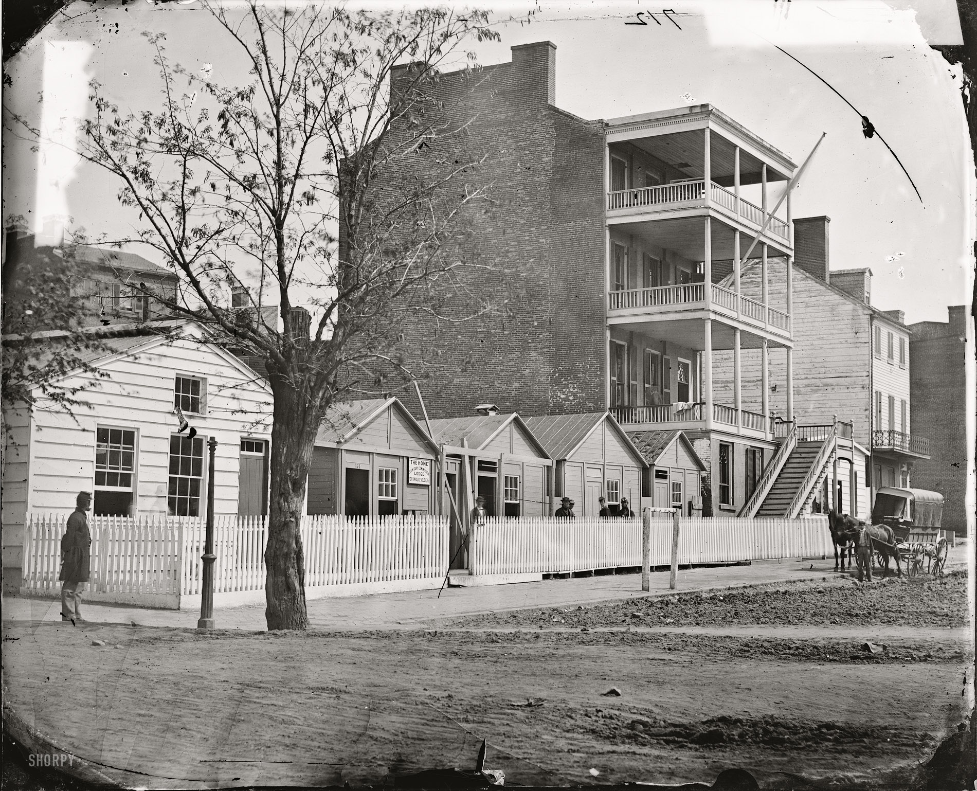 April 1865. "Buildings of the Sanitary Commission Home Lodge for Invalid Soldiers, North Capitol Street near C Street." Wet plate glass negative from photographs of the  U.S. Sanitary and Christian Commissions. View full size.