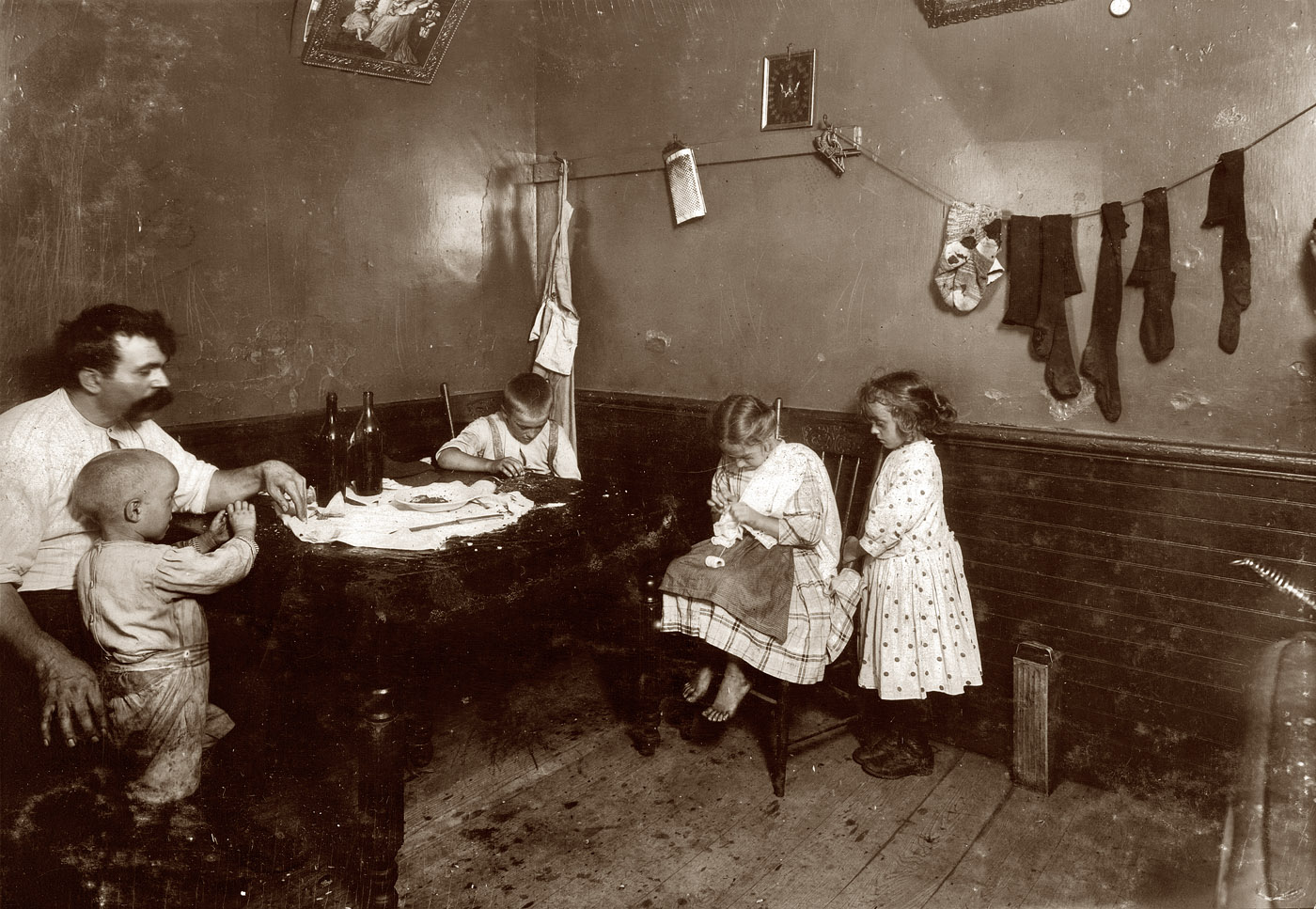 August 1912. Somerville, Massachusetts. "Annie Fedele, 22 Horace Street. Doing crochet on underwear in dirty kitchen. Said she often works here and eats out in the back yard. The people are supposed to do the work only under certain restrictions, but when the inspector and the one who delivers the goods are not around, they do as they please. A good illustration of the difficulty in trying to regulate Home Work." View full size. Photo and caption by Lewis Wickes Hine.