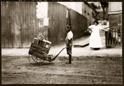 Tenement homeworker with clothing tags. Roxbury, Massachusetts. August 1912. Photograph by Lewis Wickes Hine. View full size. Homeworkers, often children, sewed tags onto finished garments or performed other piecework at home instead of going to school.