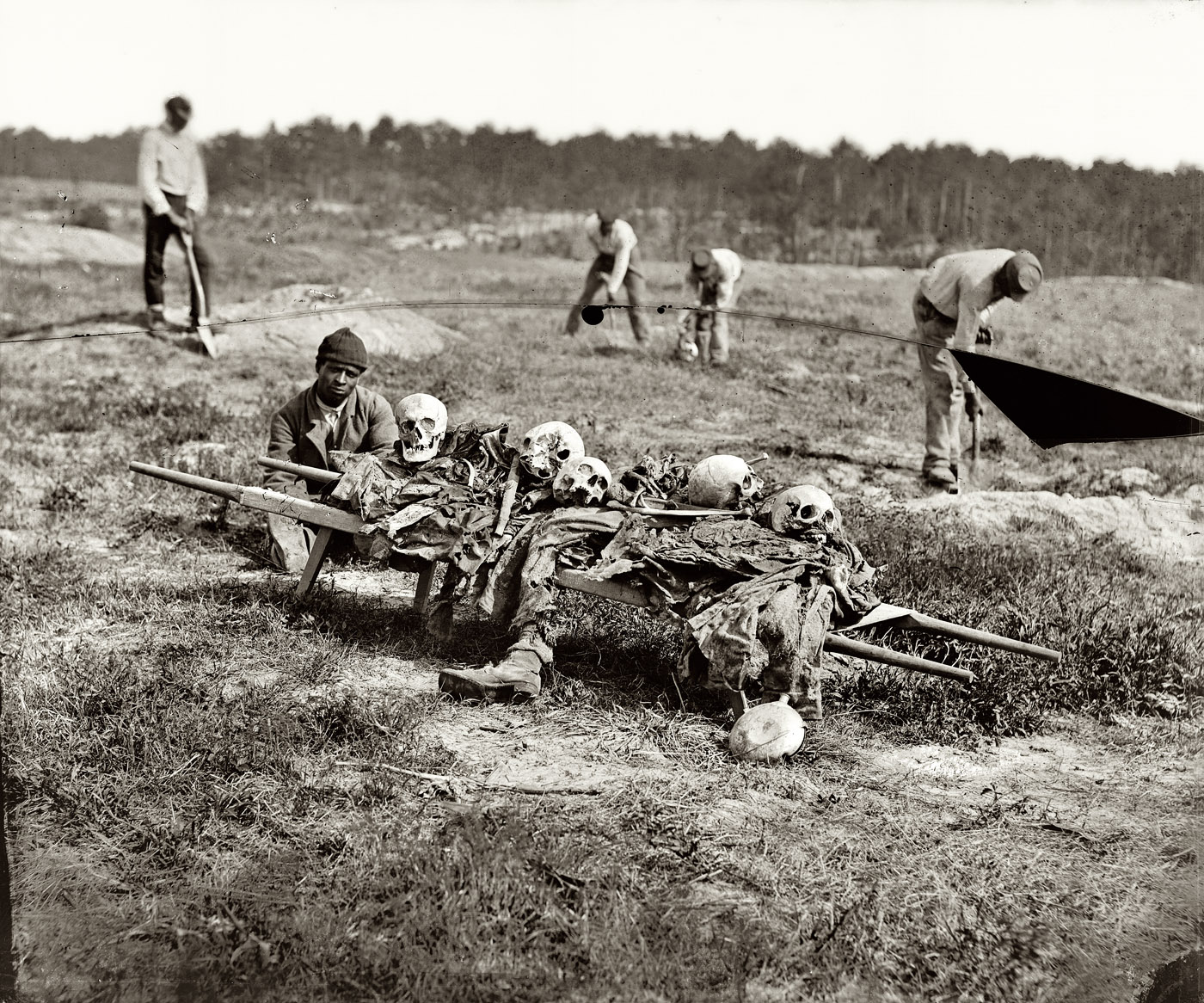 April 1865. "Cold Harbor, Va. Collecting bones of soldiers killed in the battle." Photograph from the main Eastern theater of war, Grant's Wilderness Campaign, May-June 1864. Wet plate glass negative by John Reekie. View full size.