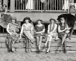 June 25, 1921. Washington, D.C. "Bathing Costume Contest." Note Felix/Krazy Kat doll.  National Photo Company Collection. View full size.
Felix the Cat?Is that Felix the Cat that the girl on the right is holding?
Re: Felix the Cat?Looks a little like Krazy Kat to me. Class?

Krazy KatLooks like Krazy Kat to me
Definitely Krazy KatCan Ignatz the Mouse be far behind?
The girl on the right looksThe girl on the right looks to me like one of the winners in the photo "Iola and Anna: 1922".  What do you think?
https://www.shorpy.com/node/2470?size=_original
SV
Krazy and GeorgeOne of George Herriman's admirers is clutching an identical doll in this photo from the Coconino County website.

Another beautiful shot of Miss Iola Swinnerton!This is my favorite Iola photo! I like her bathing suit in this one much better, too. The suit that looks like Venetian blinds might have been stylish then, but it looks ghastly to me! Fortunately, you can't make a sow's ear out of a silk purse (my father's twist on the old adage).
This isn't the only one where some of the contestants look to be in their thirties. The woman on the left is holding some kind of thing that looks like an embroidery hoop with fabric from her bathing costume attached to it.  Some kind of bag, maybe?
Swinnerton Krazy Kat ConnectionThe comic strip pioneer that shares Iola's name influenced the Krazy Kat creator.  
From an article on  Jimmy Swinnerton :
As the comic strip industry grew up around Swinnerton, he found kindred spirits. The young Walt Disney used to come to his birthday parties. Swinnerton took George Herriman (creator of Krazy Kat), Rudolph Dirks (creator of the Katzenjammer Kids), and the painter Maynard Dixon on a safari through the Arizona desert to see the Hopi Tribe of Indians do their annual snake dance...The group traveled by horseback through the Grand Canyon and Monument Valley (which later played a significant role in Krazy Kat.) It was on this trip that Swinnerton gave Dixon a half interest in the Arizona desert.
(The Gallery, D.C., Iola S., Natl Photo, Pretty Girls, Swimming)