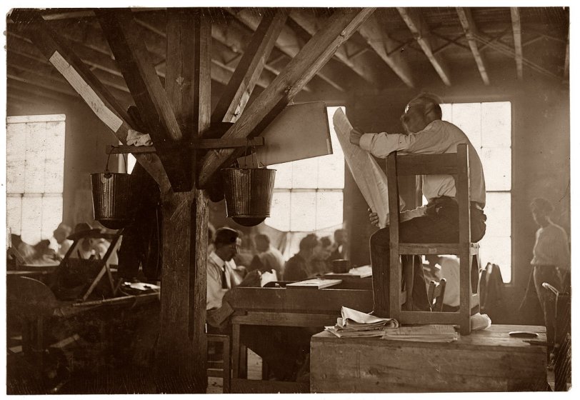 "A 'reader' in cigar factory in Tampa, Fla. He reads books and newspapers at top of his voice all day long. This is all the education many of these workers receive. He is paid by them and they select what he shall read." January 1909. View full size.
