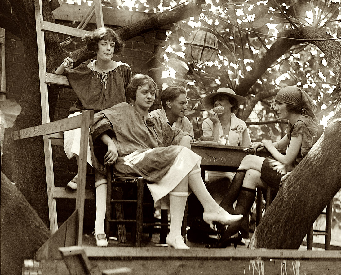 Washington. D.C. One of six National Photo glass negatives from 1921 labeled "Krazy Kat," showing a group of college-age kids painting and smoking in the yard of what seems to be a club or restaurant. Which has a treehouse. View full size.