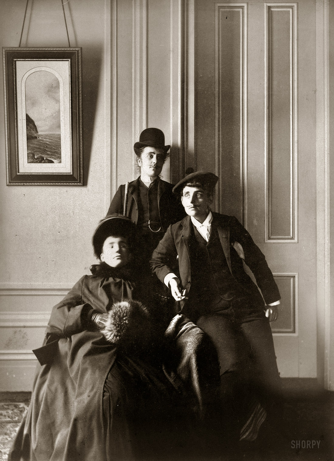 Circa 1890. "Frances Benjamin Johnston (right), full-length self-portrait dressed as a man with false mustache," posed with two similarly cross-dressing friends. The "lady" is a gent identified in a few other FBJ photos as the illustrator Mills Thompson. Albumen print by Frances Benjamin Johnston. View full size.